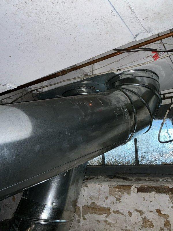 Conducted inspection of tenant-occupied property with absentee owner available by phone. Evaluated existing furnace system with good accessibility, confirming operational heat. Documented ventilation ductwork condition in utility area and inspected electrical control panel with circuit board, which appears to be functioning properly with all connections intact.