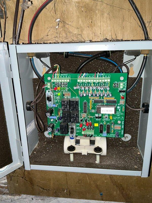 Conducted inspection of tenant-occupied property with absentee owner available by phone. Evaluated existing furnace system with good accessibility, confirming operational heat. Documented ventilation ductwork condition in utility area and inspected electrical control panel with circuit board, which appears to be functioning properly with all connections intact.