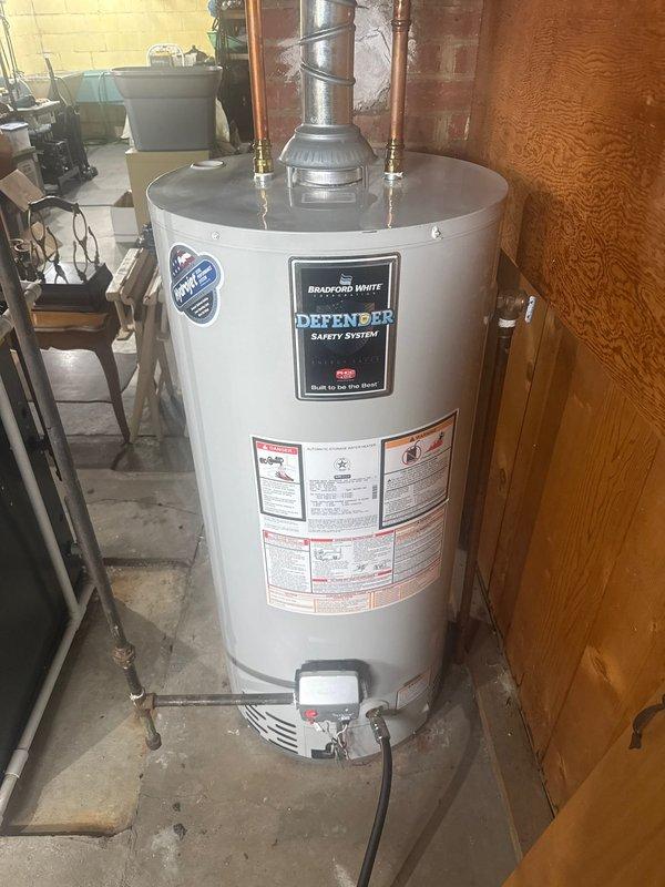 Performed routine maintenance on Bradford White water heater with Defender Safety System. Inspected expansion tank, copper supply lines, vent pipe, and all connections. System was found to be in proper operating condition with no leaks or corrosion detected.