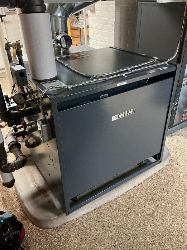Completed routine heating tune-up service on Weil-McLain boiler system. Inspected all components including pressure gauge, valves, and connected piping. System was found to be in good working condition with no visible leaks or abnormalities in the heat exchanger assembly.
