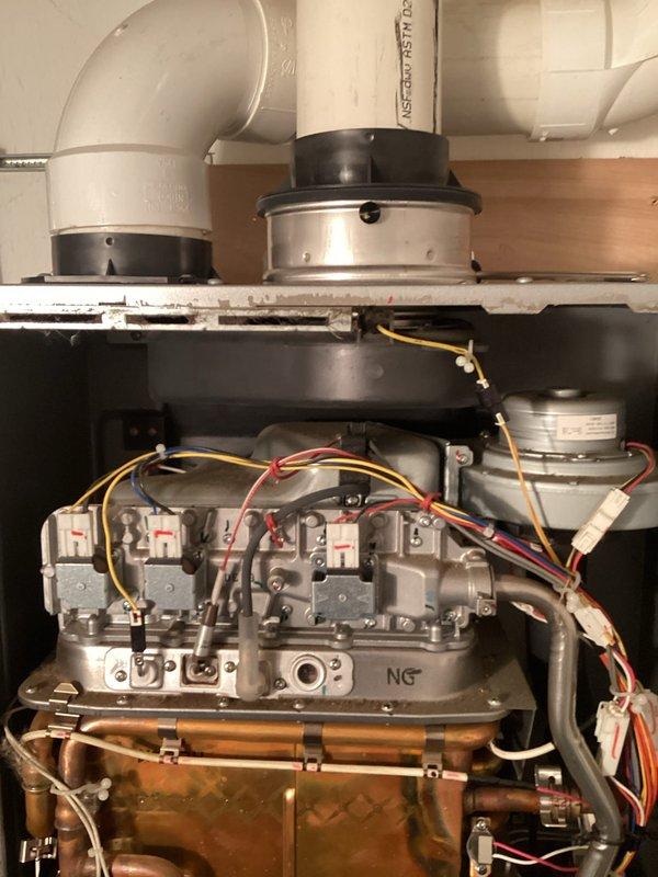 Responded to service call for tankless water heater displaying code 10. Performed diagnostic inspection of internal components, including heat exchanger, gas valve assembly, and electrical connections. Examined venting system and gas supply components to resolve the error code issue.