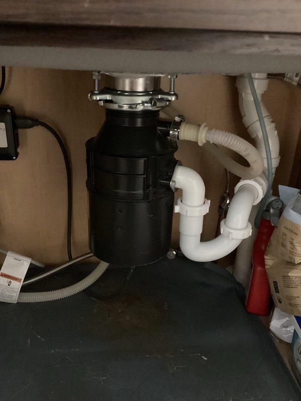 Responded to service call for non-operational garbage disposal. Performed inspection of the unit and drain assembly, identifying the issue. Reset the disposal using the reset button and verified proper operation. Cleared minor debris from sink drain to ensure optimal functionality.
