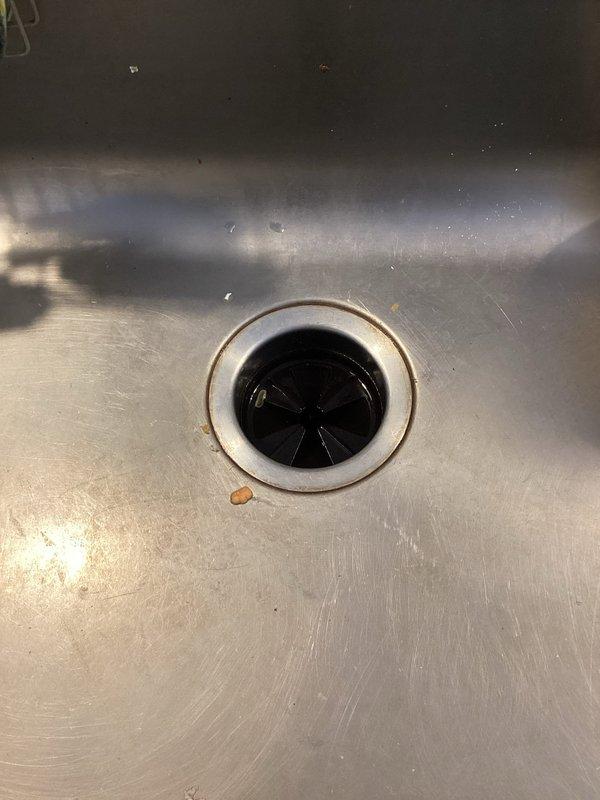 Responded to service call for non-operational garbage disposal. Performed inspection of the unit and drain assembly, identifying the issue. Reset the disposal using the reset button and verified proper operation. Cleared minor debris from sink drain to ensure optimal functionality.