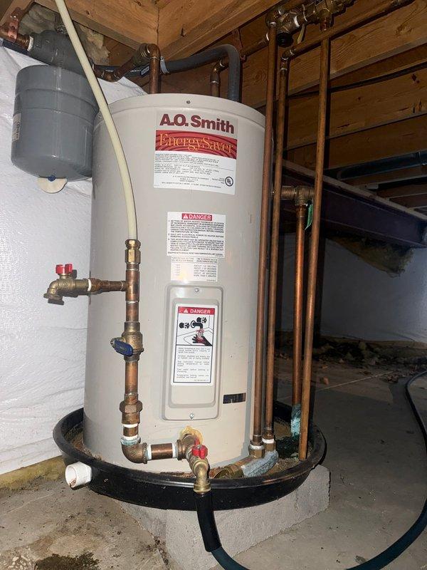 Completed flushing service on two tank-style water heaters (A.O. Smith Energy Saver and standard residential unit) to remove sediment buildup and maintain efficiency. Both units were verified operational with heat functioning properly after service completion.