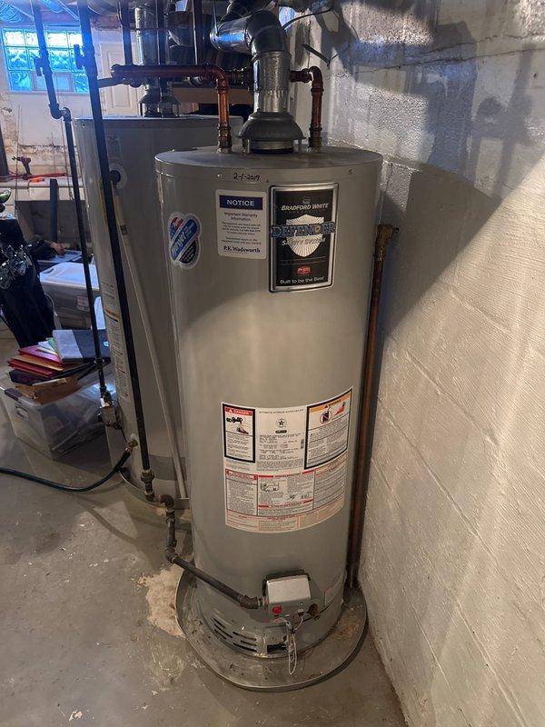 Completed flushing service on two tank-style water heaters (A.O. Smith Energy Saver and standard residential unit) to remove sediment buildup and maintain efficiency. Both units were verified operational with heat functioning properly after service completion.