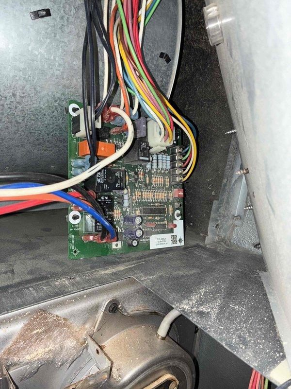 Performed routine heating tune-up on residential system, including inspection of control board and electrical components. Multimeter testing confirmed proper voltage readings of 10.3V/17.9V at circuit board terminals. Noted light dust accumulation in control enclosure but all wiring connections were secure and in good condition.