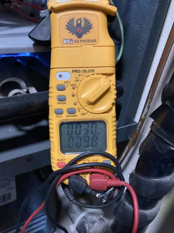 Performed routine heating tune-up on residential system, including inspection of control board and electrical components. Multimeter testing confirmed proper voltage readings of 10.3V/17.9V at circuit board terminals. Noted light dust accumulation in control enclosure but all wiring connections were secure and in good condition.