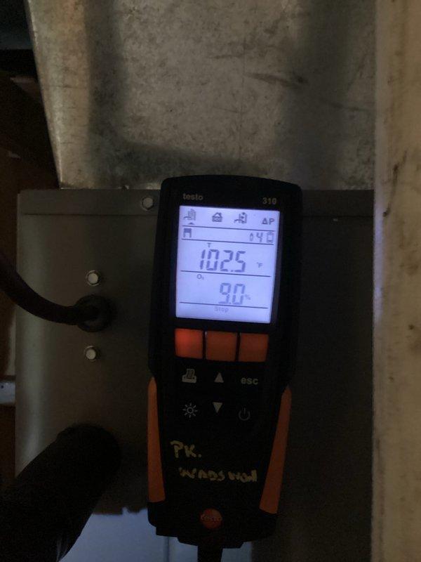 Performed routine heating maintenance on residential furnace system. Conducted combustion analysis using Testo 310 analyzer, recording CO2 levels at 10.25% and O2 at 9.0%. Inspected internal components with access panel open and verified proper venting through PVC exhaust system.