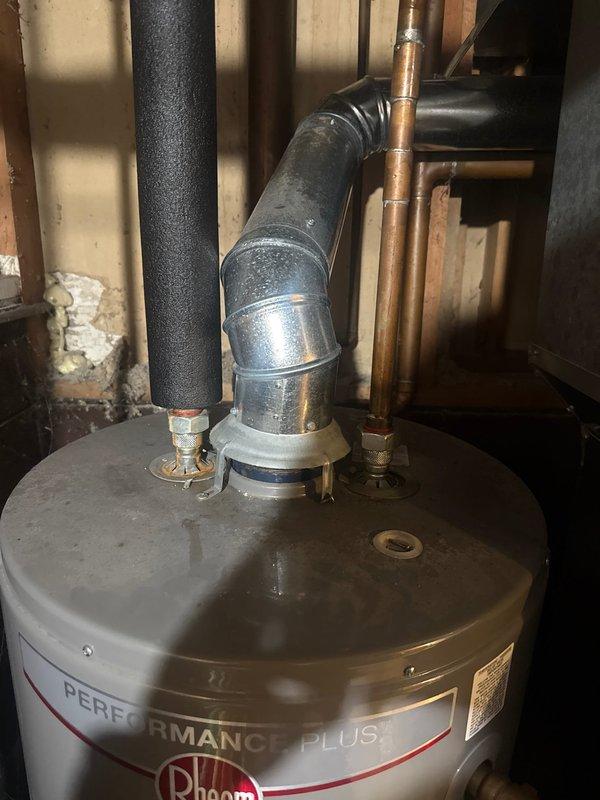 Responded to customer report of leaking hot water tank. Upon inspection, identified a Rheem Performance Plus water heater with active leak. Installed replacement unit of same model, connected to existing copper water lines, black insulated exhaust vent, and metal vent pipe with proper fittings. Verified proper operation after installation.