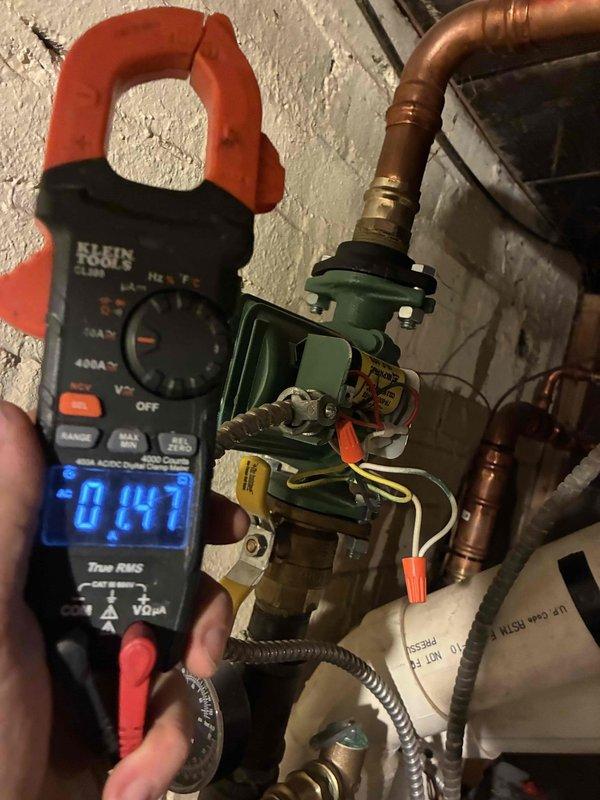Responded to service call for Weil McLain WM97-155 boiler with suspected Low Water Cutoff issue. Performed electrical diagnostics using multimeter and clamp meter, measuring voltage at circulator pump (0.41A reading). Identified and resolved electrical connection issue at the pump assembly on the primary loop.