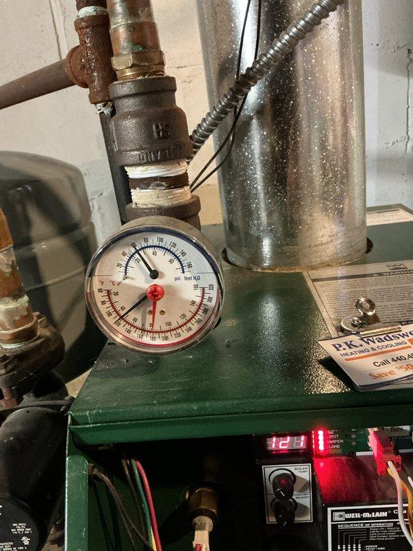 Performed scheduled boiler maintenance service. Inspected pressure gauge, temperature readings, and checked all copper piping connections for proper operation. Visual examination of the green boiler unit confirmed system is functioning within normal parameters with no visible leaks or corrosion issues requiring immediate attention.