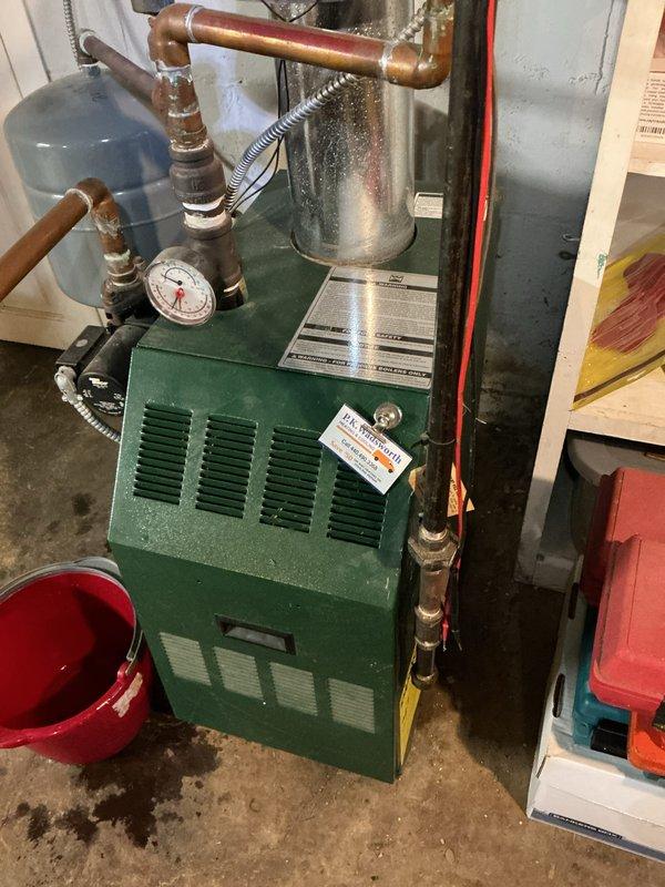 Performed scheduled boiler maintenance service. Inspected pressure gauge, temperature readings, and checked all copper piping connections for proper operation. Visual examination of the green boiler unit confirmed system is functioning within normal parameters with no visible leaks or corrosion issues requiring immediate attention.