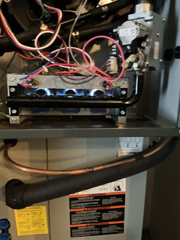 Performed annual heating maintenance on a gas furnace that is approximately 12-15 years old based on visual inspection. Observed proper flame pattern during operation with no signs of delayed ignition. Inspected electrical connections, burner assembly, and ventilation system - all components functioning within acceptable parameters despite age of unit.