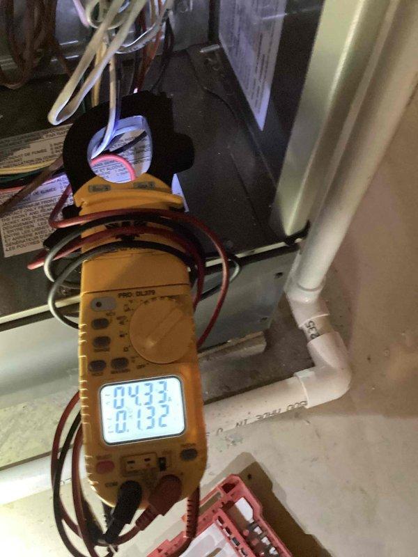 Performed diagnostic testing on furnace that was making unusual noises despite being only one year old. Conducted electrical measurements with multimeter, checking voltage and resistance values across components. Readings showed normal parameters (-04.33, 0.132) indicating proper electrical function with no issues detected in the power supply or control circuits.