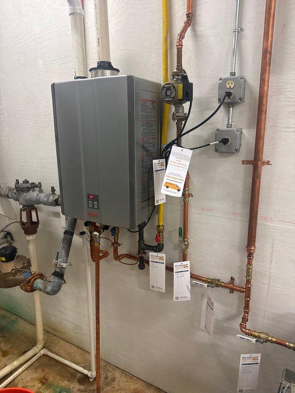 Performed routine maintenance flush on customer's wall-mounted Rinnai tankless water heater. Inspected all copper pipe connections, valves, and electrical components for proper function. System is operating correctly with no issues found during service.