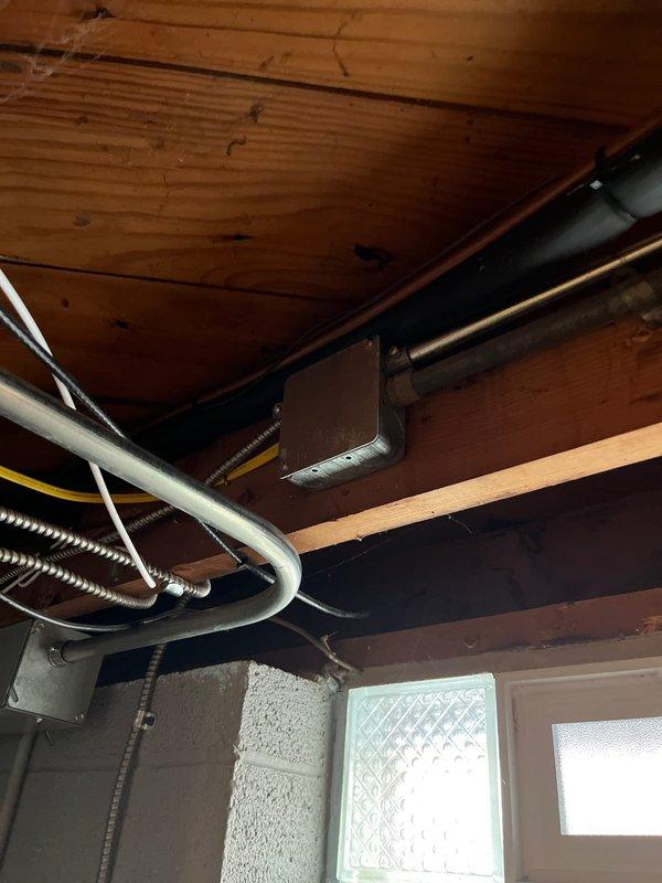 Installed new 120V circuit connecting from main panel to junction box. Work included running electrical conduit through basement ceiling joists and terminating connections at breaker panel. Proper circuit was established with appropriate wire colors (black, white, red, green) maintaining code-compliant organization within the panel.