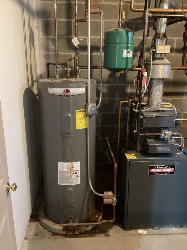 Conducted comprehensive inspection of existing Rheem water heater installation in utility room. System includes copper piping connections, expansion tank mounted on concrete block wall, and integration with adjacent HVAC equipment. Customer seeking estimate for complete water heater replacement. Current unit appears functional with no visible leaks or damage.