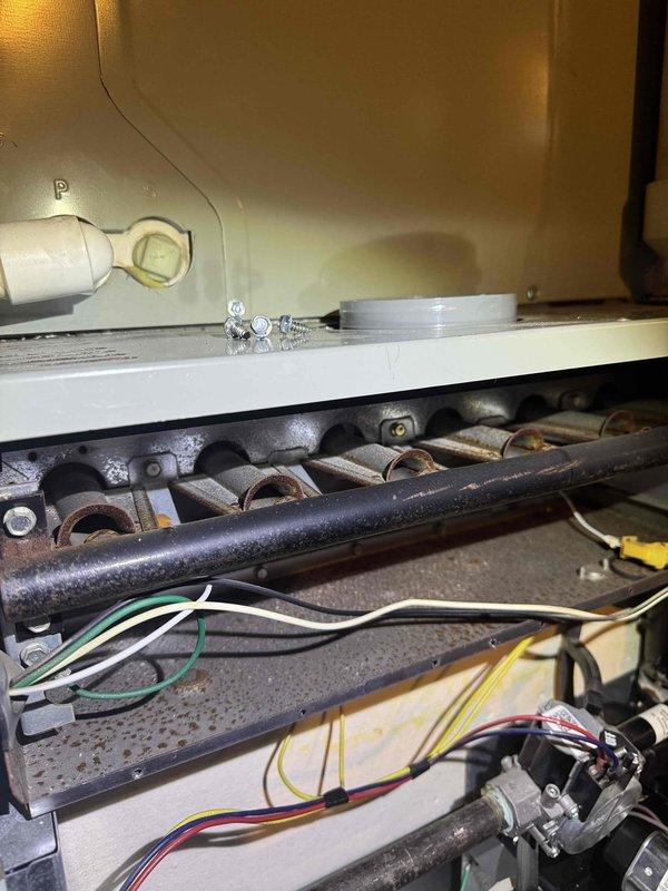 Responded to no heat complaint on aging furnace. Diagnostic inspection revealed heat exchanger failure with visible stress cracks and crystalline formation on metal surfaces. System condemned due to safety concerns and customer advised of replacement options.
