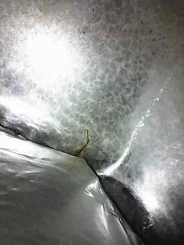 Responded to no heat complaint on aging furnace. Diagnostic inspection revealed heat exchanger failure with visible stress cracks and crystalline formation on metal surfaces. System condemned due to safety concerns and customer advised of replacement options.