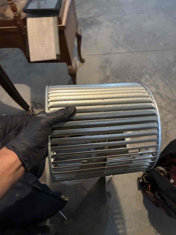 Performed comprehensive blower wheel cleaning service on HVAC system. Removed cylindrical metal blower wheel assembly, thoroughly cleaned accumulated dust and debris from all fan blades and housing, then reinstalled component to restore optimal airflow and system efficiency.