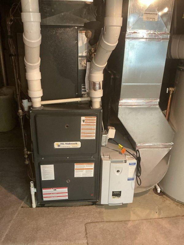 Performed routine maintenance on a 6-year-old P.E. Wadsworth furnace system with attached Aprilaire humidifier. Inspected all components including PVC intake/exhaust vents, ductwork connections, and electrical systems. System is functioning properly with no issues identified.