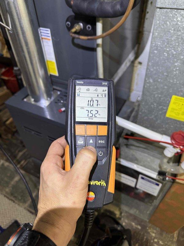 Performed scheduled heating tune-up service on two identical furnace systems (84/84). Conducted full inspection with front panels removed to access internal components. Tested combustion efficiency using Testo 310 analyzer, which measured 10.7% CO2 and 75.2% temperature readings, indicating proper operation within specifications. Both systems were functioning correctly with no issues detected.