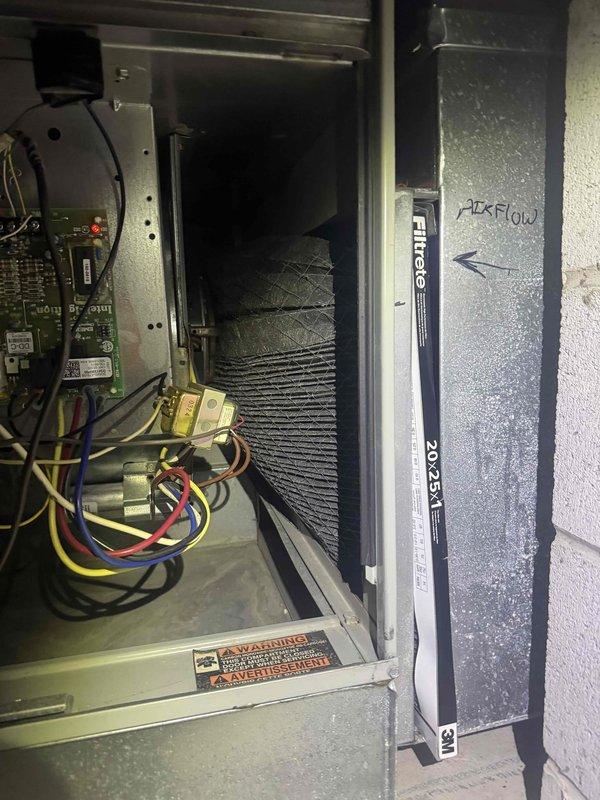 Performed scheduled heating tune-up maintenance on HVAC system. Inspected blower wheel assembly which appeared in good condition with no visible damage or debris. Noted significant dust accumulation on existing Filtrete 20x25x1 air filter and verified proper airflow direction as marked on installation area.