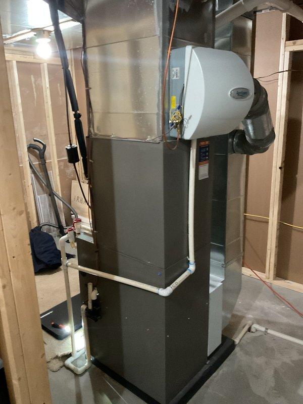 Performed comprehensive maintenance on residential furnace system in unfinished basement. Opened access panel to inspect internal components including blower motor, electrical connections, control board, and PVC condensate drainage system. Verified proper operation of red valve assembly and examined all electrical wiring and connections for safety and functionality.