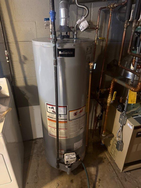 Completed fulfillment and installation of a Reliance water heater in utility area. Installation included connecting copper pipes with brass fittings, PVC pipes with blue valves, and proper venting with flexible metal vent pipe. All connections were secured and system was tested for proper operation.