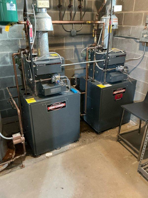 Conducted comprehensive evaluation of existing hydronic heating system featuring dual Hydrotherm boilers and a Rheem Professional water heater with direct integration. System includes expansion tank and extensive copper piping network with multiple valves and gauges. Assessment performed to determine feasibility of replacing with 1-2 combi boiler units as requested by customer.