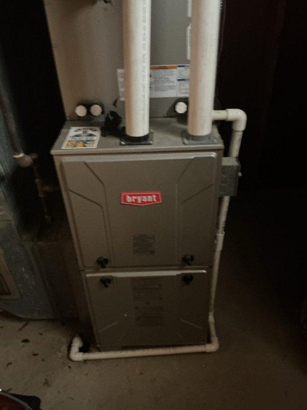 Responded to customer complaint of burning smell after filter replacement on Bryant furnace system. Inspected unit and surrounding ductwork in basement area. Determined new filter installation caused temporary burning odor due to dust accumulation on heat exchanger - normal condition that resolves after brief operation. Verified proper system function with no safety concerns.