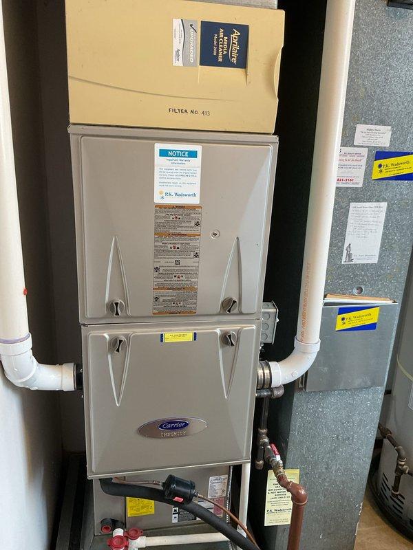 Performed scheduled winter maintenance on a Carrier HVAC system. Inspected blower motor assembly, circuit board connections, and wiring integrity. Examined filter housing (Filter No. 413) and checked PVC venting system and copper line connections. All components operating within normal parameters.