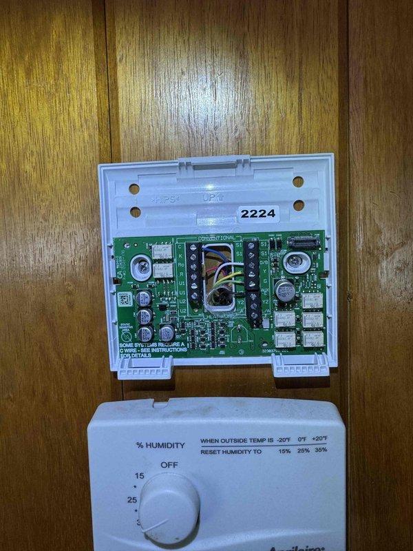 Completed warranty service call to replace defective thermostat/humidity controller on Amana HVAC system. Removed faulty unit with damaged circuit board and installed new replacement thermostat with proper wiring connections to yellow, white, and green terminals. System tested and confirmed proper operation of humidity control settings.