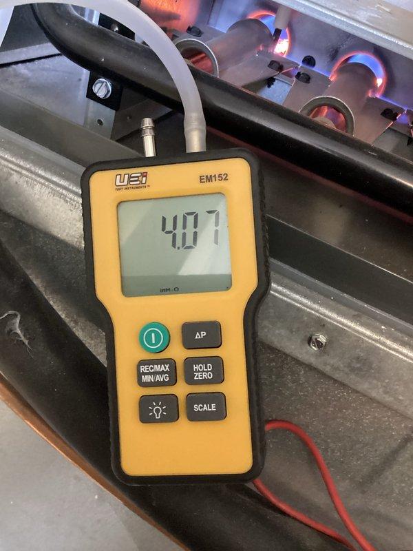 Performed scheduled maintenance on two furnace systems. Conducted electrical testing using UEi G2 Phoenix multimeter to verify proper voltage readings. Measured gas pressure/combustion parameters with UEi EM152 manometer, confirming proper operation with reading of 4.07" WC while visually inspecting flame pattern and burner operation.