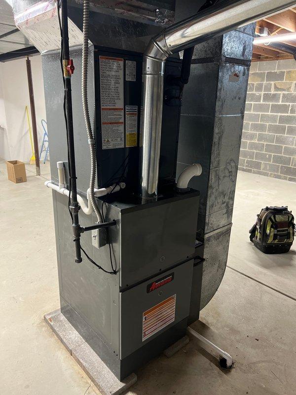 Completed installation of a complete HVAC system including an 80% efficiency furnace, air conditioning unit, AprilAire humidifier with digital control panel (set at 25% humidity), and liner. System was properly mounted on concrete pad with all necessary ductwork, PVC venting, and electrical connections installed according to manufacturer specifications.