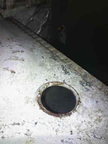 Inspected older secondary furnace that was failing to provide heat to multiple bedrooms. Identified significant moisture damage and mold growth in the unit's housing along with corrosion around the vent opening. Determined system requires replacement due to age-related deterioration and water damage compromising safe operation.