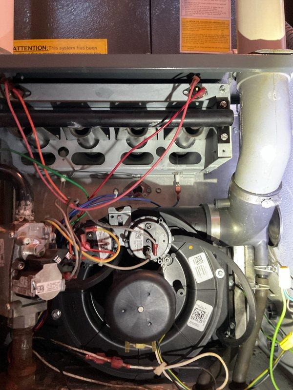Responded to customer report of loud knocking noise from furnace during normal operation. Inspected system including control board, wiring connections, and blower assembly. Determined noise was caused by loose heat exchanger panels vibrating against housing during operation. Secured panels and verified proper system function with no abnormal noise during test cycle.