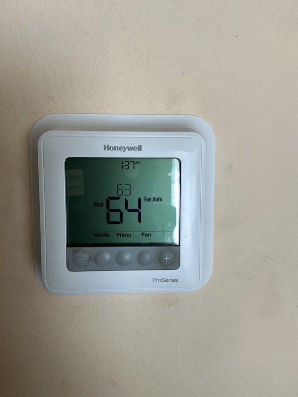Responded to follow-up no-heat call after previous service visit. Conducted gas pressure test using Klein Tools ET180 Differential Manometer, measuring 1.26 inH₂O. Discovered thermostat displaying abnormally high temperature reading of 137°F while actual set points were 63-64°F, indicating faulty thermostat as source of heating system failure.