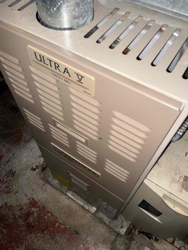 Diagnosed non-operational Ultra V furnace showing significant deterioration with visible mold/contamination on exterior surfaces. Unit requires full replacement due to age, condition, and safety concerns. Presented multiple budget-friendly replacement options to customer who was experiencing complete loss of heat.