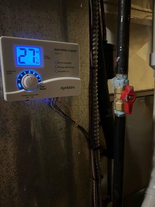 Successfully installed new furnace with AprilAire humidifier system. Completed electrical connections and verified proper humidifier control panel operation, currently displaying 27% relative humidity with all indicator systems functioning correctly.