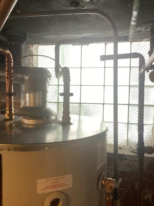 Performed scheduled maintenance on tanked water heater system. Inspected expansion tank, copper supply lines, and ventilation components. All connections secure with proper function verified during service visit.