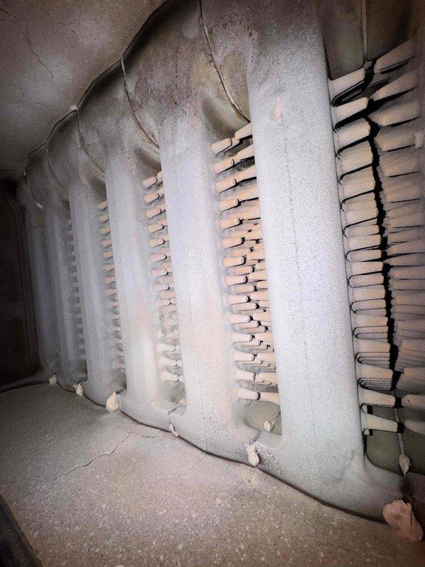 Responded to no heat call for aging boiler system. Upon inspection, found significant corrosion and deterioration in the heat exchanger with visible cracks and rust damage. Replaced failed thermocouple as diagnosed and performed system test to confirm proper ignition and operation.