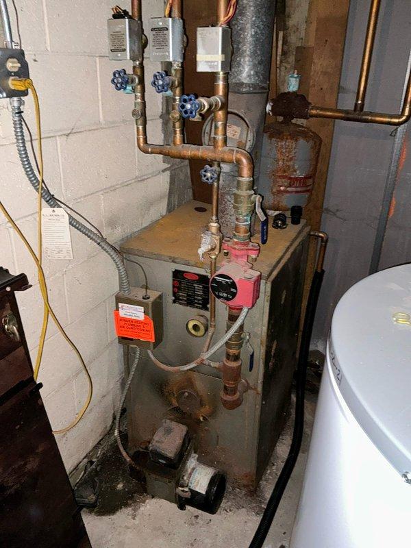 Conducted an assessment for conversion from existing boiler system to forced air gas system. Current installation features an aging boiler with visible rust, multiple zone valves, and copper distribution piping. Customer is planning to have gas service installed to the property and is obtaining multiple estimates for the conversion project.