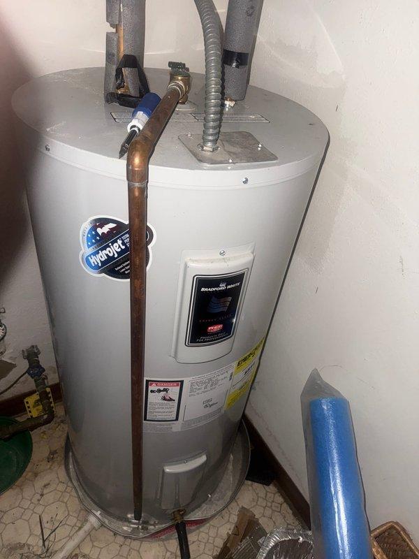 Completed water heater inspection and verification for MVP Water Heater Fulfillment program. Unit appears to be a HydroJet model with proper installation in utility area. Confirmed all connections are secure with no visible leaks or damage to supply lines, drainage valve, or insulated pipes.