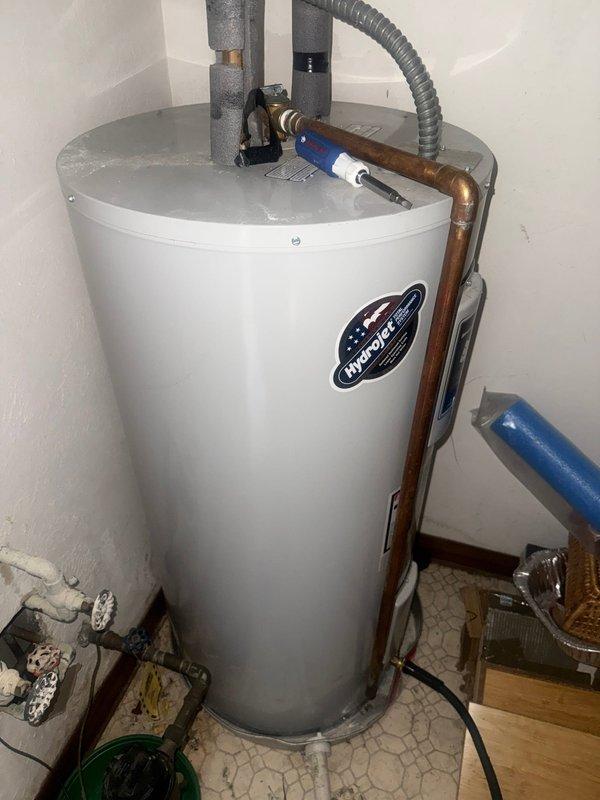 Completed water heater inspection and verification for MVP Water Heater Fulfillment program. Unit appears to be a HydroJet model with proper installation in utility area. Confirmed all connections are secure with no visible leaks or damage to supply lines, drainage valve, or insulated pipes.