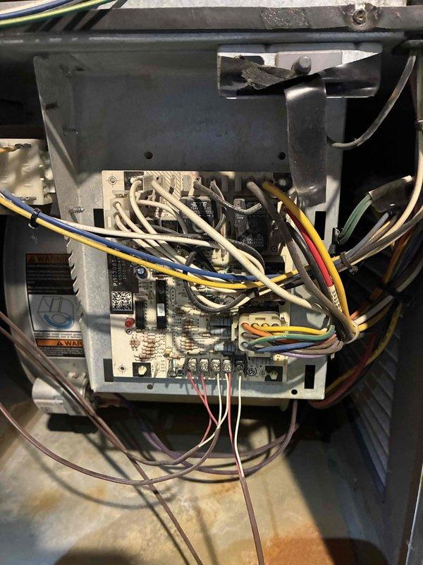 Performed scheduled heating tune-up service, inspecting circuit board connections and wiring in control system. Checked electronic sensor functionality with purple wire connections. All components operating correctly with no issues found.