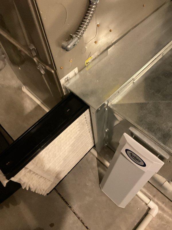 Diagnosed intermittent furnace operation causing no heat condition. Inspected electrical connections and flame sensor assembly, finding significant carbon buildup on sensor probe. Cleaned flame sensor rod to restore proper flame detection and system operation. Unit now functioning normally with consistent heat.