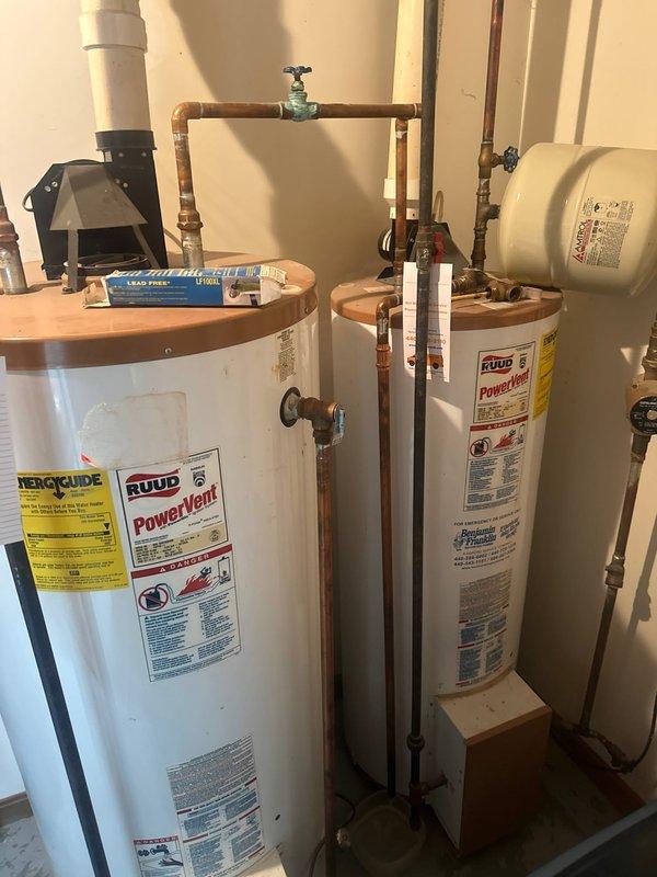 Performed maintenance service on customer's twinned water heater system consisting of two RUUD PowerVent tanks that are over 30 years old with visible aging on copper piping and components. Provided customer with estimate for replacement with a single 75-gallon tank as requested, as current units are at end of service life.