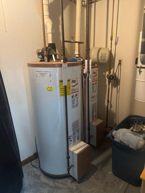 Performed maintenance service on customer's twinned water heater system consisting of two RUUD PowerVent tanks that are over 30 years old with visible aging on copper piping and components. Provided customer with estimate for replacement with a single 75-gallon tank as requested, as current units are at end of service life.