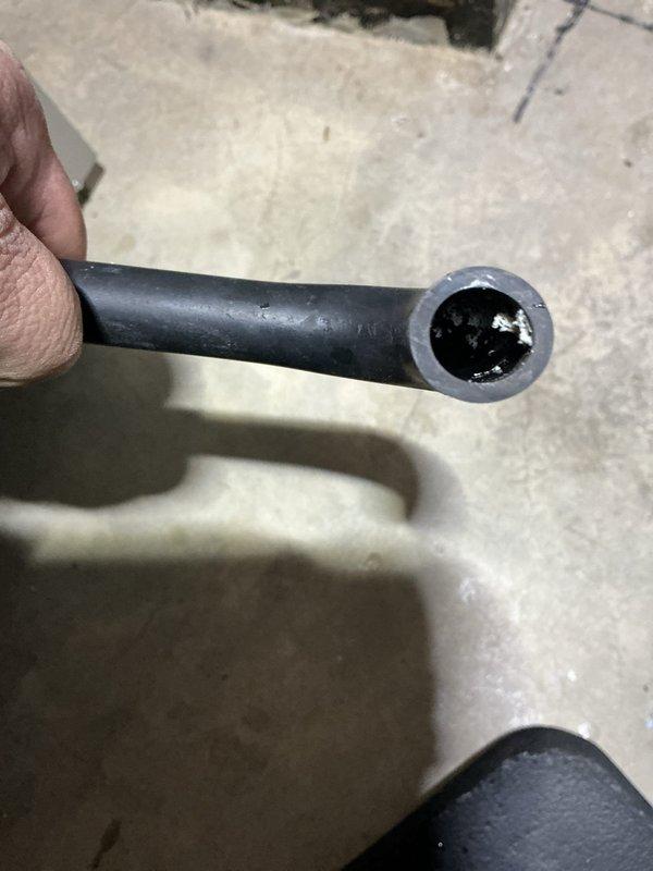 Investigated no heat complaint on furnace. Discovered significant tar-like buildup inside condensate drain pipe causing blockage. Also found damaged control wire with frayed insulation at junction point within the unit. Cleared obstructed drain line and repaired wiring to restore proper system operation.